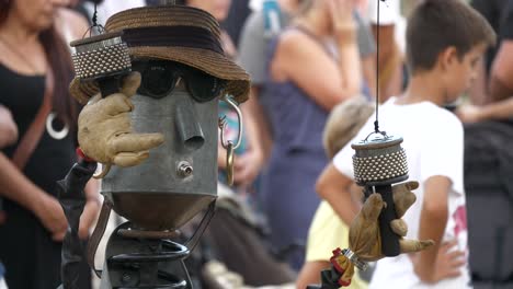 Musical-crafted-puppet-figure-in-sunglasses,-shaking-"La-Merçe"-holiday-event-in-Barcelona