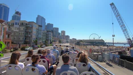 POV-from-roof-of-tour-bus-driving-on-Alaska-Way-along-Seattle's-waterfront-on-a-sunny-summer-day
