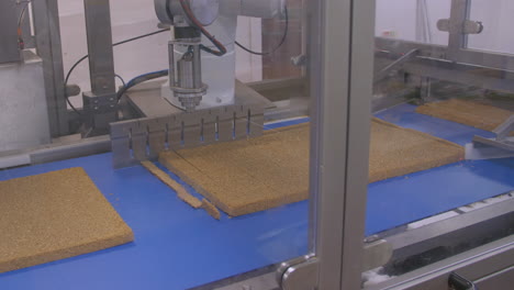 A-robotic-arm-cuts-flapjacks-into-bar-sizes-ready-for-packaging