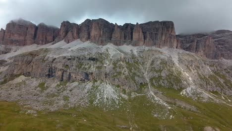 Rock-formation-in-the-Dolomite-mountain-area-in-northern-Italy-on-an-overcast-cloudy-winter-day,-Aerial-drone-reveal-shot