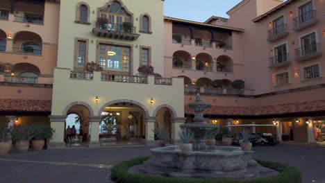 Sheraton-Hotel-in-Cabo,-Mexico-courtyard-pan-left-across-fountain-gardens-entrance