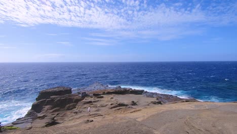 Blue-Pacific-Ocean-foaming-at-volcanic-rocks-of-coast-at-island-Oahu-on-Hawaii