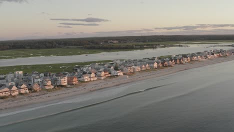 Wide-aerial-view-Housing-property-along-Wells-Beach-seaside-shoreline,-Maine