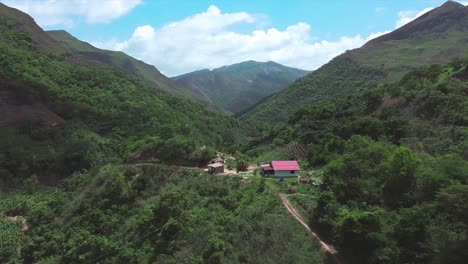 Daytime-drone-flight-over-isolated-house-located-in-a-wooded-area-in-Laguneta,-in-a-group-of-mountains-in-the-state-of-Miranda,-Venezuela