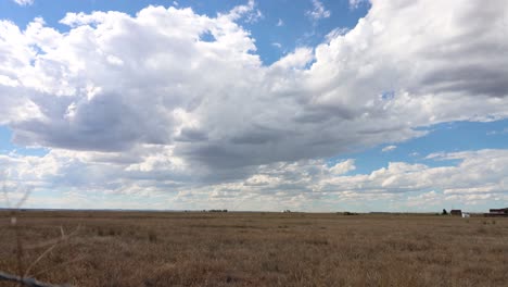 A-western-prairie-time-lapse-with-thousands-of-puffy-white-clouds-and-shadows-crawling-across-the-sky