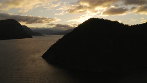 Aerial-shot-of-the-silhouette-of-hills-beside-Nahuel-Huapi-lake-at-sunset