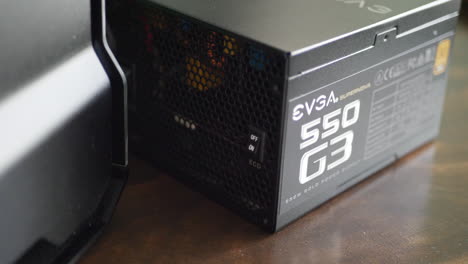 An-EVGA-Gold-rated-power-supply-next-to-a-pc-case-during-a-gaming-build-assembly