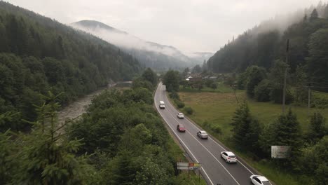 Cars-driving-on-road-through-valley-of-the-Carpathian-mountains