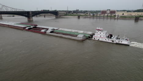 Tugboat-steadily-pushes-barge-of-cargo-up-Mississippi-River