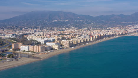 Aerial-drone-hyperlapse-timelapse-of-Fuengirola-in-Spain-and-the-beachfront-from-over-the-sea-looking-back