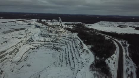 Quarry-and-oild-and-gold-mine-hole-in-forest-in-Canada-orbit---Drone-4k-Aerial
