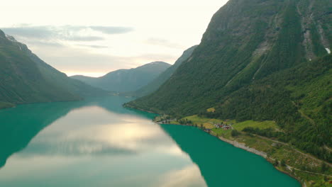 Casas-A-Orillas-Del-Río-Con-Las-Verdes-Montañas-De-Nordfjord-En-Stryn,-Condado-De-Vestland,-Noruega