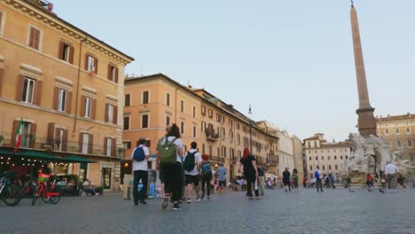Rapid-circling-and-low-angle-view-of-tourist-at-Piazza-Navona-in-Rome-walking-in-slow-motion