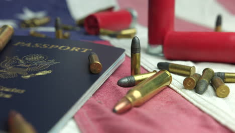 Shotgun-Shell-Cartridge-And-Bullets-Scattered-All-Over-United-States-Passport-Lying-On-American-Flag