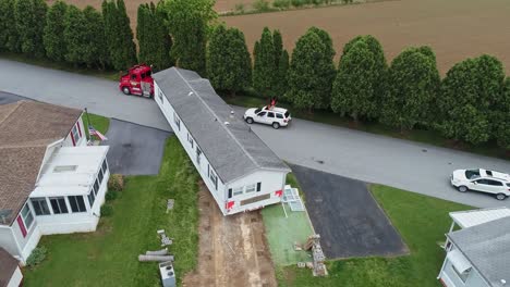 Drone-View-of-a-Mobile,-Manufactured-or-Prefab-Home-Being-Removed-from-a-Park