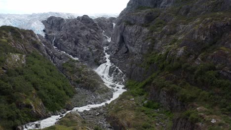 Weißer-Bach-Fällt-Aus-Den-Schneebedeckten-Bergen-Von-Alaska-–-Luftaufnahme