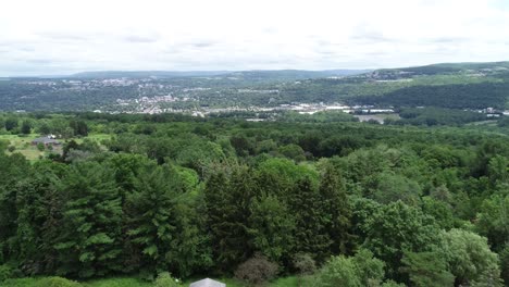 A-backward-dolly-of-the-city-of-Ithaca-New-York-showing-the-valley,-colleges,-and-lush-greenery