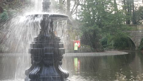 Autumnal-ornate-English-fountain-sprinkle-spray-in-landmark-historic-garden-attraction