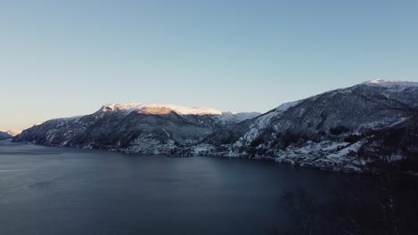 Aerial-showing-Vaksdal-from-Langhelle---Snowy-landscape-and-fjords-in-early-morning