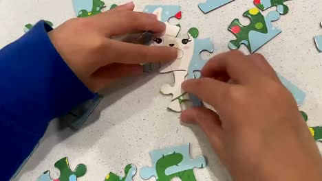 Small-hands-putting-together-a-Christmas-puzzle-in-time-lapse
