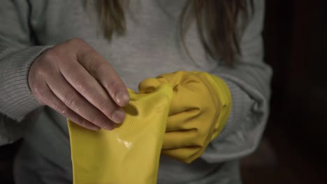 Frauenhände,-Die-Gelbe-Gummihandschuhe-Anziehen,-Mittlere-Aufnahme