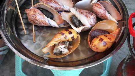 Close-up-of-fresh-colorful-sea-snails-in-metal-dish