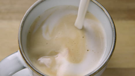 ZOOM-OUT,-creamy-frothy-oat-milk-finishes-a-cappuccino,-60fps