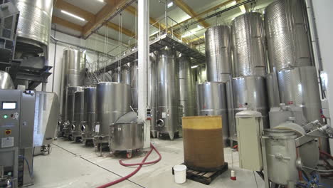 Large-tanks-in-warehouse-at-winery,-wide-shot