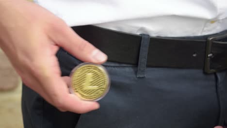 Young-Businessman-Gets-An-Physical-Golden-Litecoin-Out-Of-His-Poket