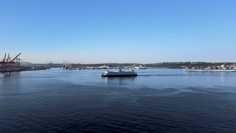 The-Bremerton-Ferry-approaching-pier-52-Seattle,-Elliot-Bay,-aerial-track