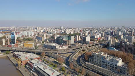 Aerial-view-of-a-highway-crossing-through-a-neighborhood-in-Buenos-Aires-city-at-daytime