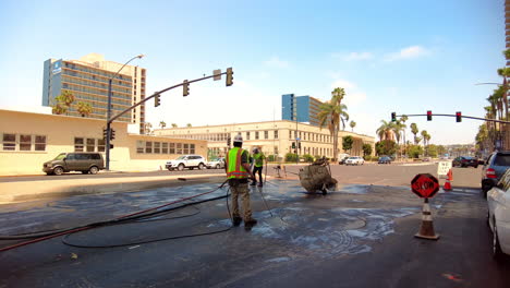 Man-Working-On-City-Road-Pavement-In-San-Diego,-California