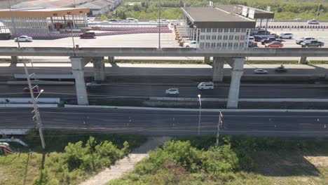 Tracking-shot-along-Toll-Gateway-on-Highway,-Vehicles-driving-road-Underneath