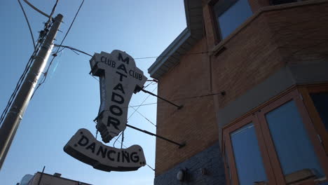 Wide-panning-shot-looking-upwards-to-the-historic-Matador-Club-sign-in-Toronto