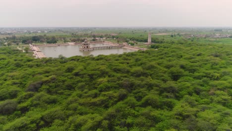 Aerial-Flyover-Of-Forest-Surrounding-Travel-Destination-Hiran-Minar-In-Pakistan