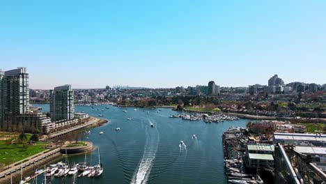 Breathtaking-Aerial-of-Harbor-with-Boats-in-Busy-Waterway-along-City-Landscape---Slow-Motion