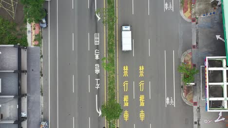 Bird-Eye-View-Aerial-Drone-Footage-of-Asphalt-Road-in-Taiwan,-drone-flying-along-the-straight-road
