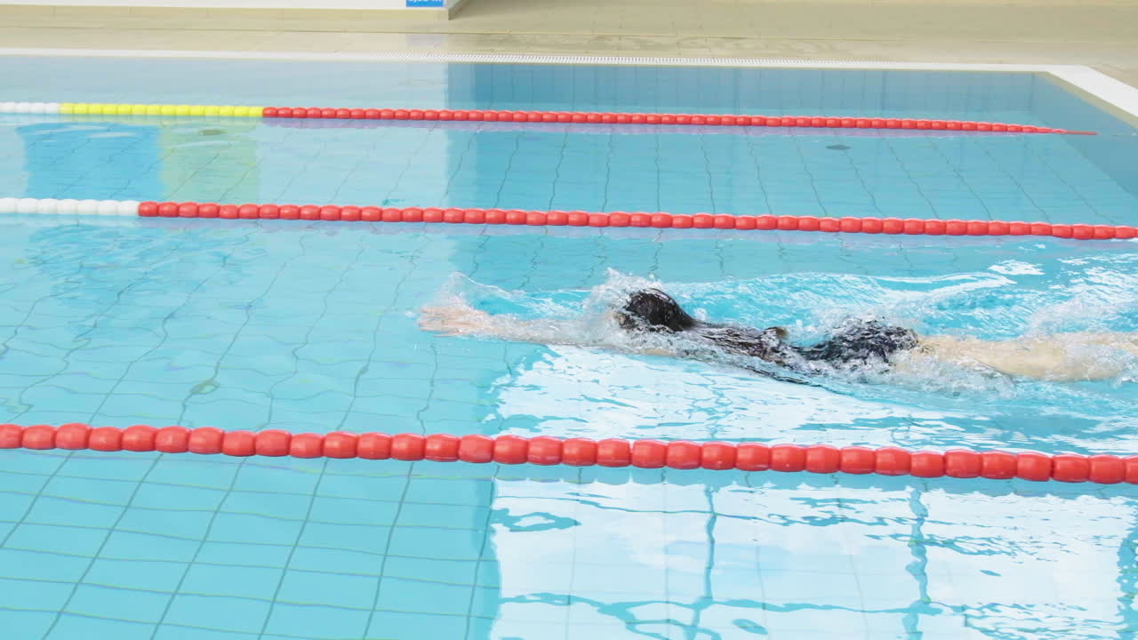 Premium stock video - Slow motion female young swimmer in swimsuit ...