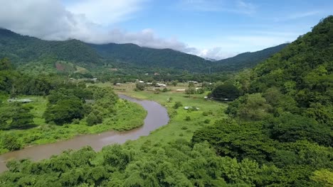 Windy-River-flowing-through-Valley-surrounded-by-Lush-Green-Mountains-in-Northern-Thailand