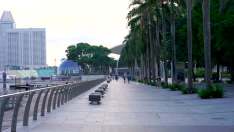 People-exercising-outdoors-early-morning-at-the-Olympic-walk,-Marina-Bay,-Singapore