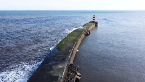 An-aerial-drone-shot-of-Seaham-Lighthouse,-in-the-North-East-of-England-on-a-bright-day