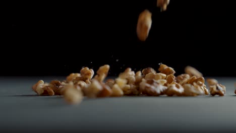 Walnuts-fall-on-the-table-in-slow-motion
