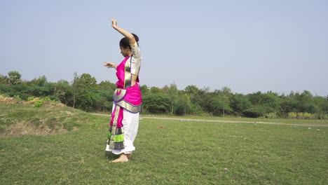A-bharatnatyam-dancer-displaying-a-classical-bharatnatyam-pose-in-the-nature-of-Vadatalav-lake,-Pavagadh