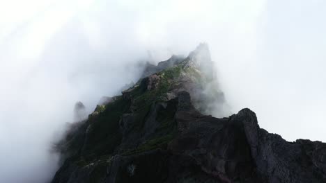 Drone-shot-moving-slowly-forward-over-the-foggy-landscape-of-Pico-das-Torres-in-Madeira