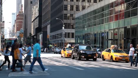 Wide-shot-of-people-crossing-busy-Manhattan-street-in-New-York-City