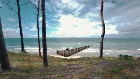 Relaxing-in-the-Hammock-by-the-Windy-Baltic-Sea-and-Enjoying-Sea-View-Stedicam-Shot