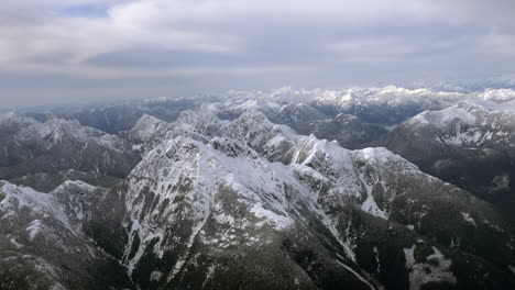 Aerial-close-up-shot-of-top-of-a-snow-covered-mountain