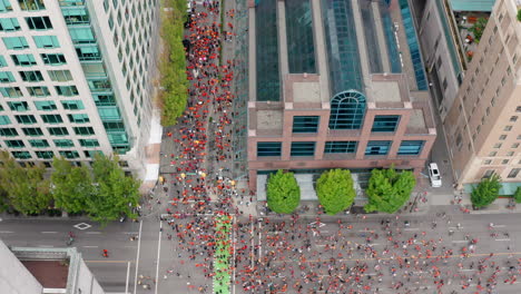 Overhead-Drone-View-of-the-Cancel-Canada-Day-march-as-Native-People-Protest-against-Discrimination-in-Vancouver-BC-Canada,-Top-Down-Aerial-Shot-Moving-Forward-in-UHD
