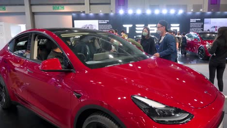 A-family-tries-a-Tesla-Motor-model-Y-at-the-American-electric-company-car-Tesla-Motors-booth-during-the-International-Motor-Expo-showcasing-EV-electric-cars-in-Hong-Kong