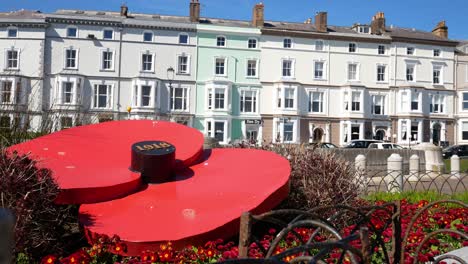Llandudno-seaside-giant-poppy-flower-war-memorial-remembrance-garden-on-North-Wales-promenade-dolly-left